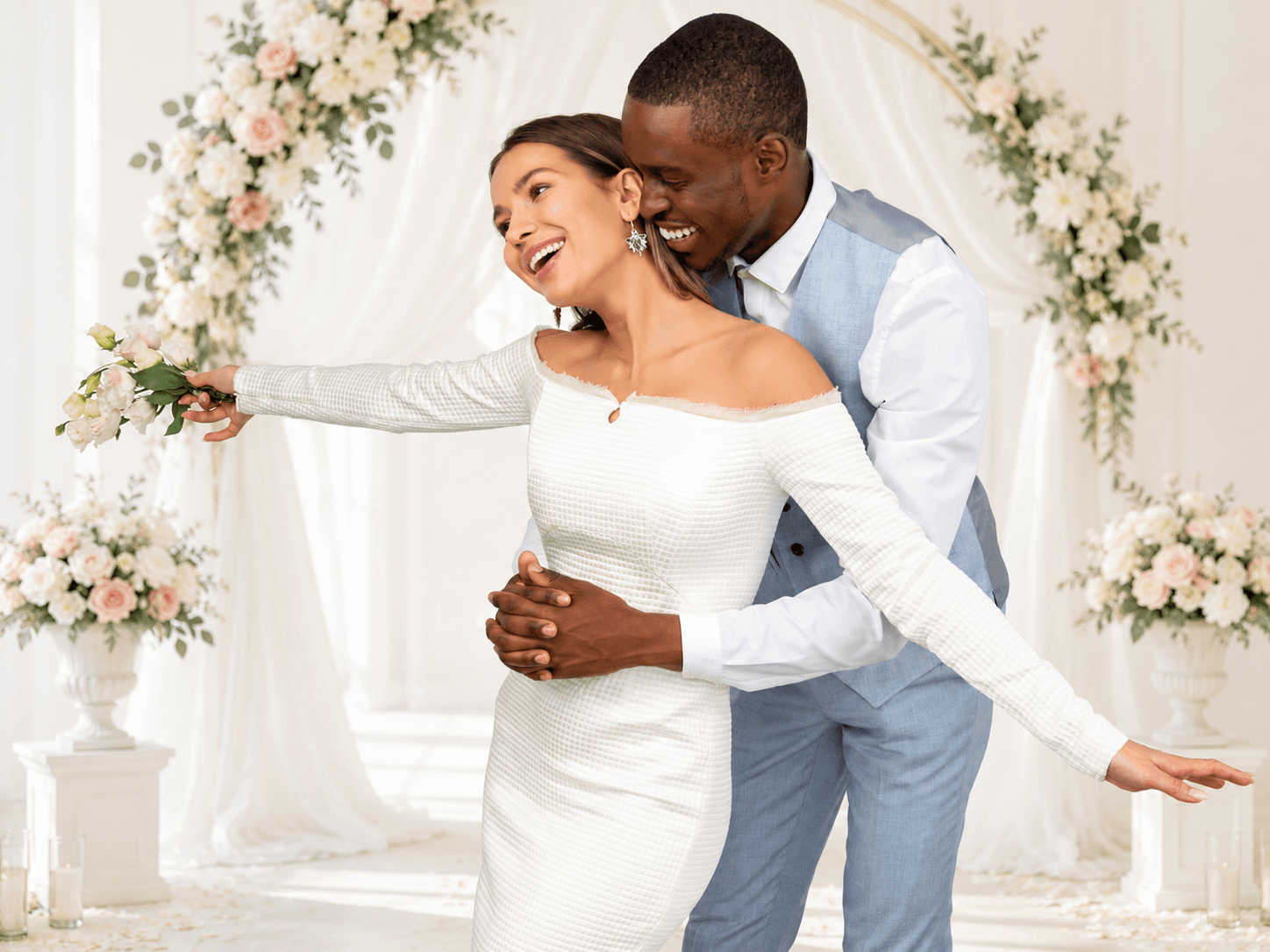 Newlyweds sharing their first dance beneath a floral arch