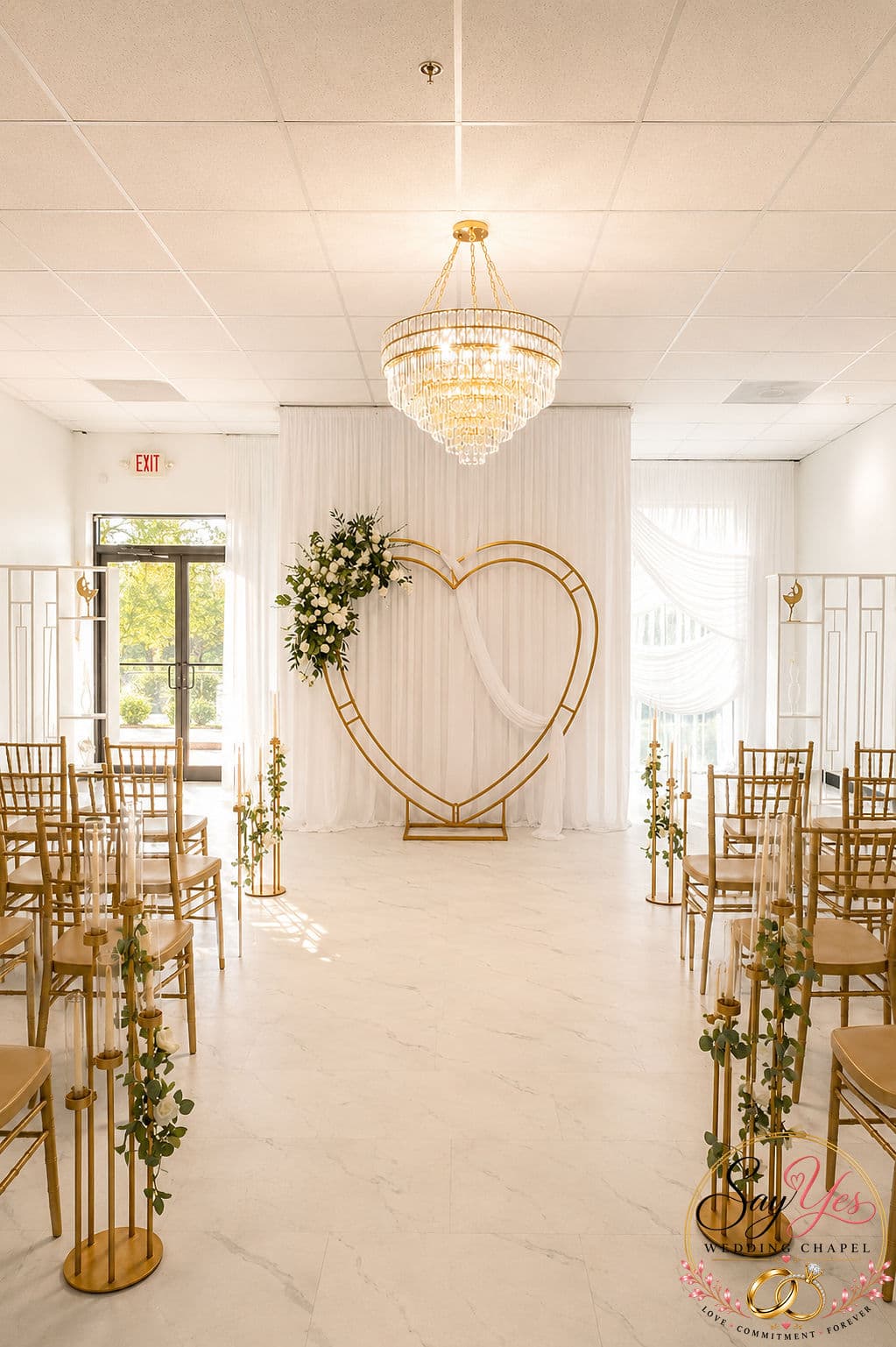 Gold heart arch with white florals at the end of the chapel aisle